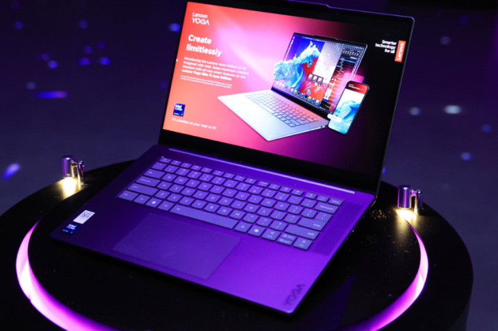 Lenovo Yoga Slim 7i Aura Edition laptop in Luna Grey displayed on a minimalist desk setup.