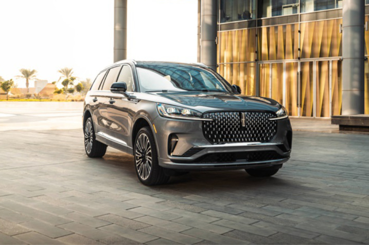 Front exterior of the 2025 Lincoln Aviator showcasing the redesigned grille and LED headlamps with an aerodynamic profile, highlighting its luxury SUV elegance.