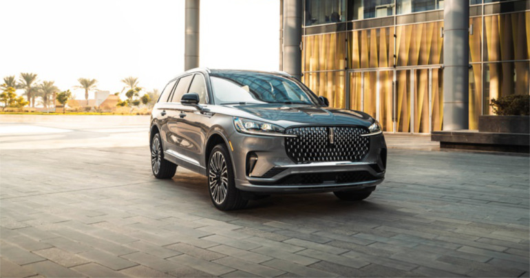 Front exterior of the 2025 Lincoln Aviator showcasing the redesigned grille and LED headlamps with an aerodynamic profile, highlighting its luxury SUV elegance.