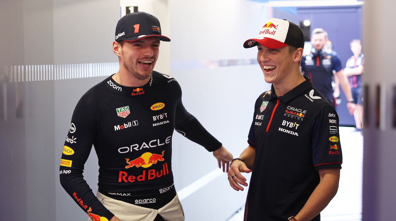 Liam Lawson celebrating his confirmation as a Red Bull Racing driver for the 2025 F1 season, alongside team principal Christian Horner and Max Verstappen.