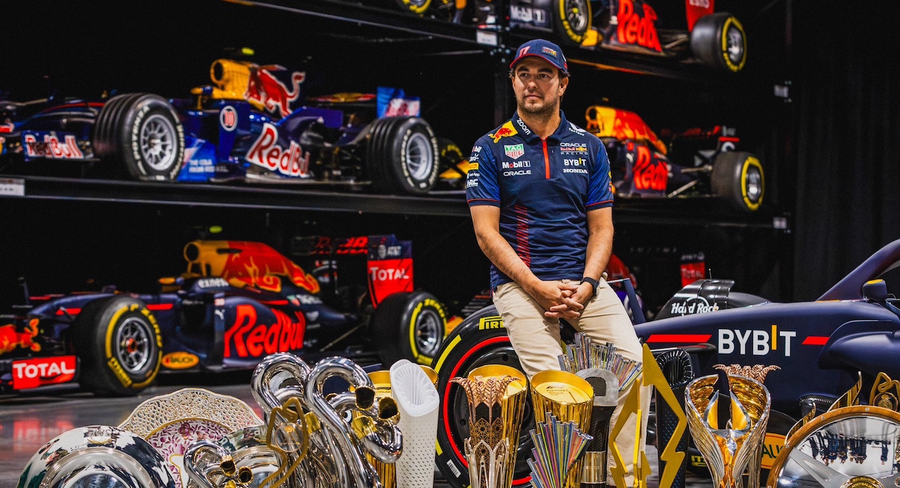 Sergio Perez poses with trophies.