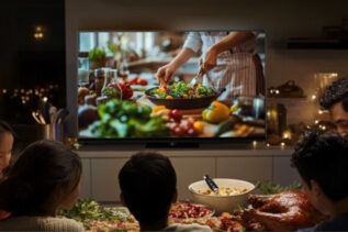 Family gathered around Toshiba TV Z670 with Christmas decorations in the background