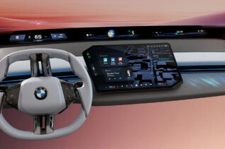 BMW Panoramic Vision display showing full-width windshield HUD and central touchscreen interface