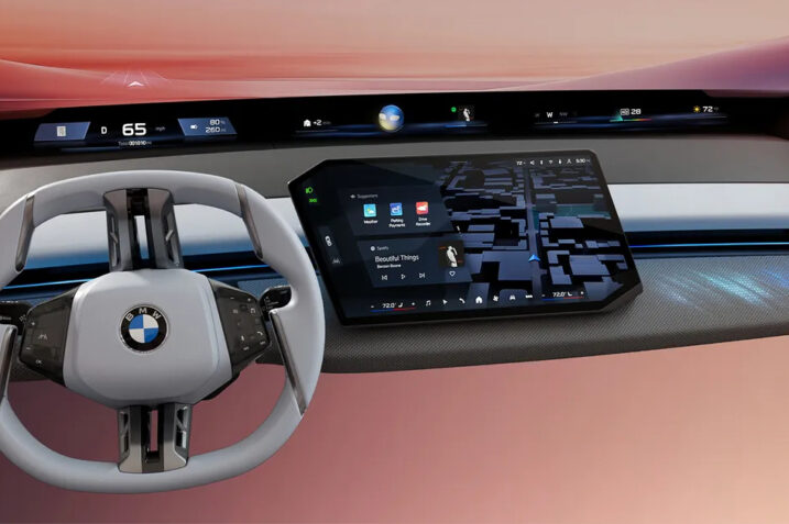 BMW Panoramic Vision display showing full-width windshield HUD and central touchscreen interface