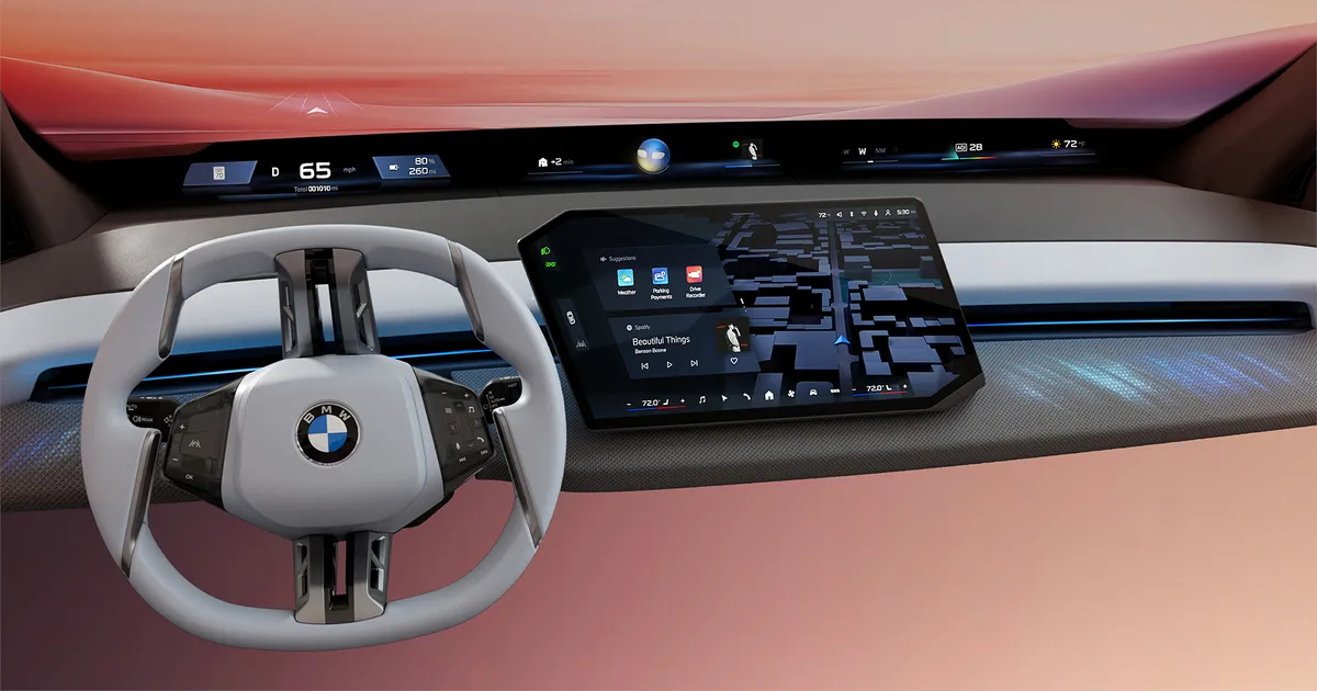 BMW Panoramic Vision display showing full-width windshield HUD and central touchscreen interface