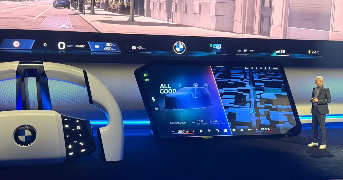 BMW Panoramic Vision display showing full-width windshield HUD and central touchscreen interface