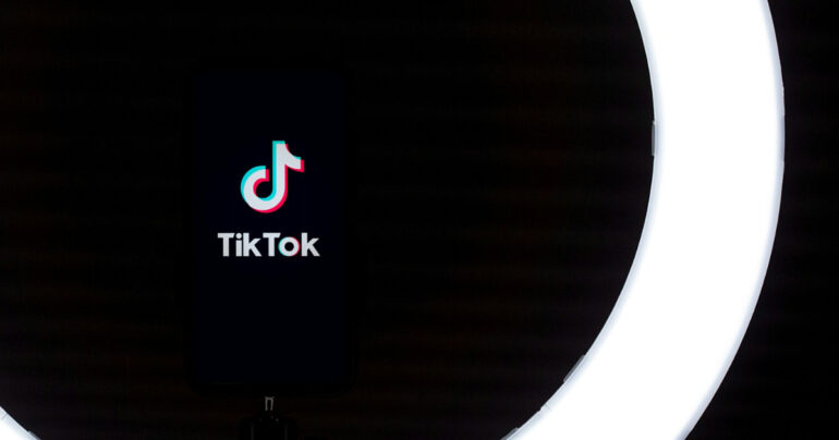 TikTok app logo displayed on a smartphone screen against a black background